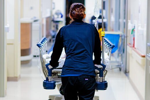 Stretcher being transported down hospital hallway