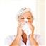 Older woman blowing nose