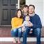 Mother, father and two little children sitting on front porch