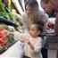 Family of three shopping in produce aisle