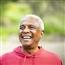 Senior man smiling and hiking in woods