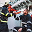 Firefighter giving another firefighter supportive handshake