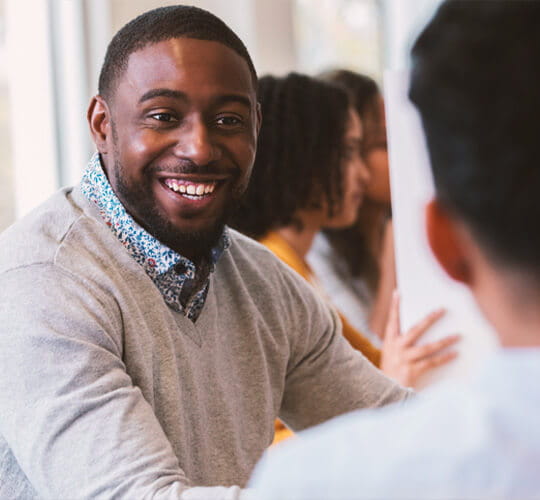 Happy man smiling in meeting