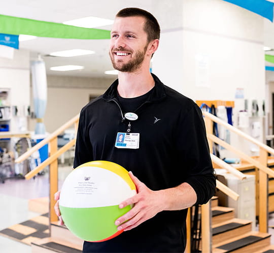 Physical therapist in rehab gym