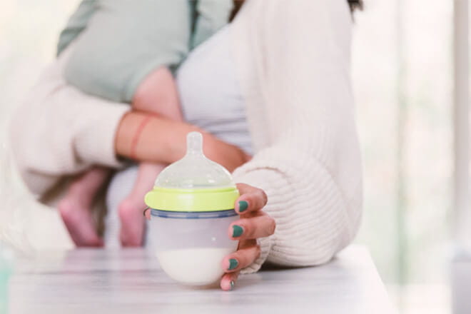 Mother and baby with bottle of milk