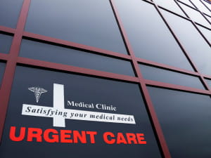 urgent care sign on a building window