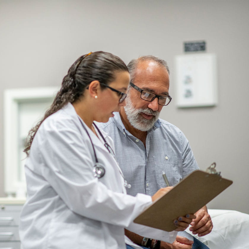 female doctor helping patient with paperwork