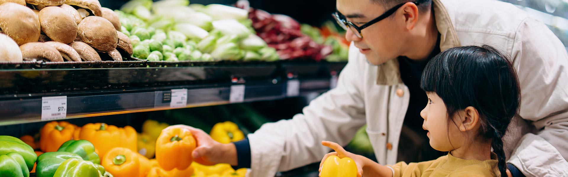 Father and daughter selecting produce