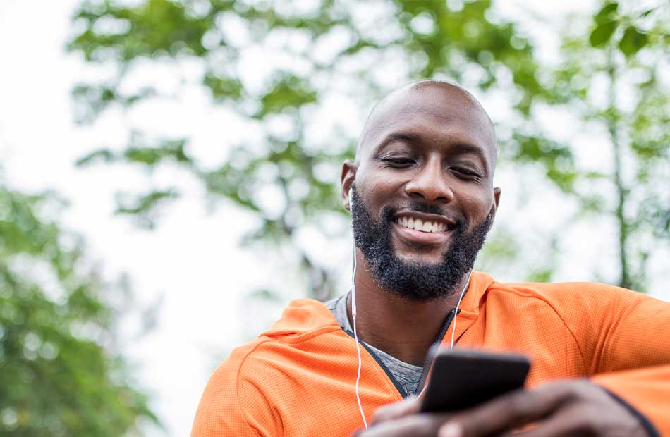 Man smiling looking at his phone